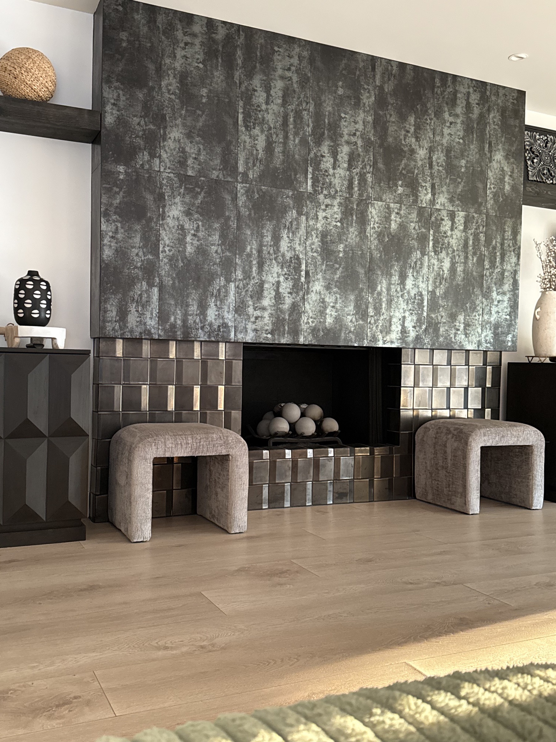 Finished sculptural fireplace wall and warm wood flooring at Valle de Luna